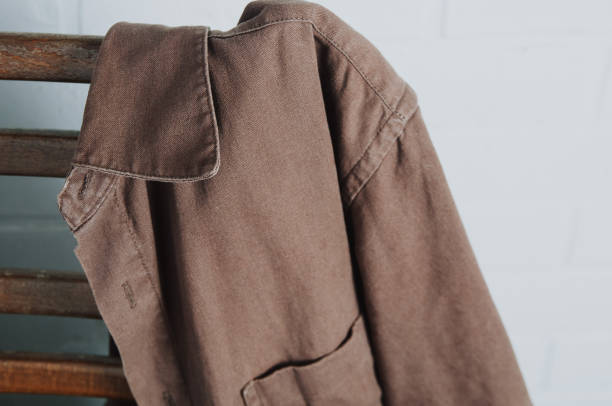 istock Brown men's shirt hanging on old chair 1087486936