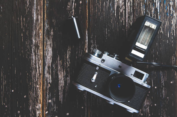 istock Old camera on dark wooden background 1087487062