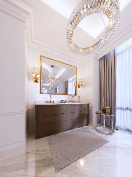 istock Modern wooden vanity with a mirror in a gold frame and sconces on the wall, a low table with decor and a rug with a chandelier. 1087489730