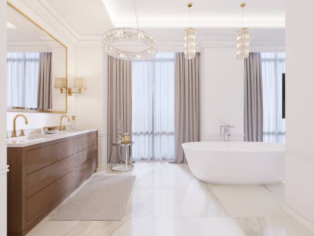 istock Modern bathroom with vanity and a mirror in a gold frame with sconces on the wall, a low table with decor, shower and a fashionable bath. 1087491740
