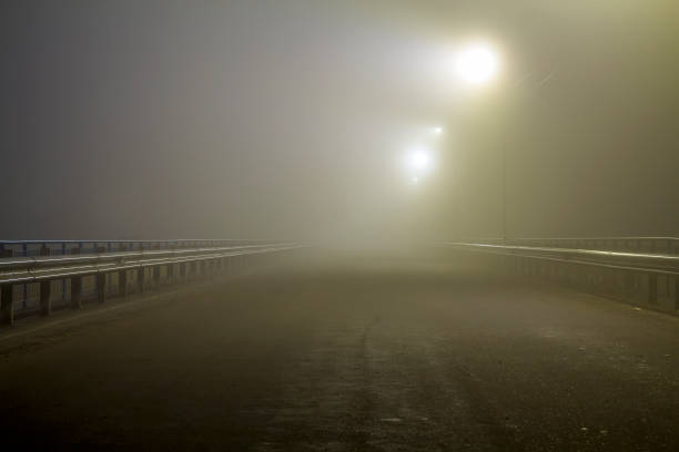 istock Thick fog over empty road at night 1087494070