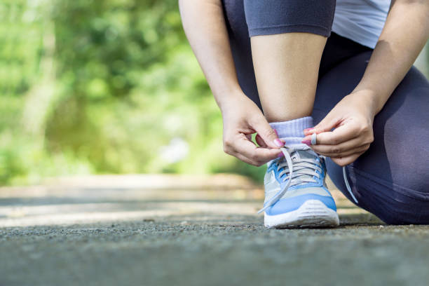 istock woman runner typing shoelace closeup 1087502362