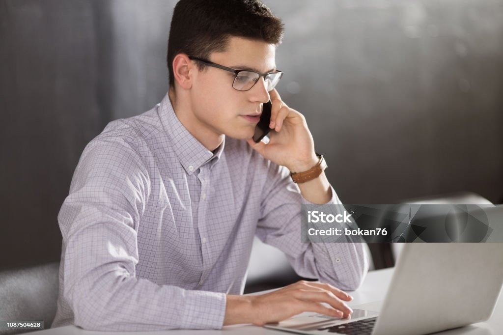 Young businessman using smart phone Adult Stock Photo