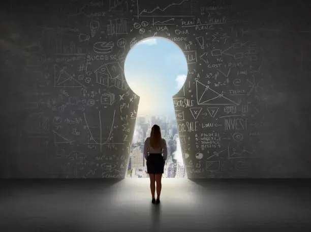 Photo of Business woman looking at keyhole with bright cityscape concept