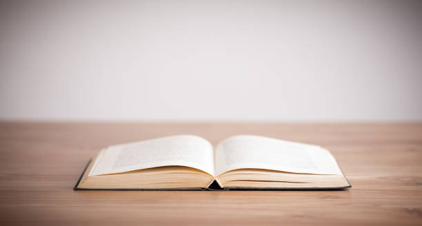 istock Open book on wood floor 1087508360