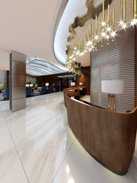 istock Reception area in a modern hotel with wooden reception counters and large pendant gilded chandeliers. 1087508936