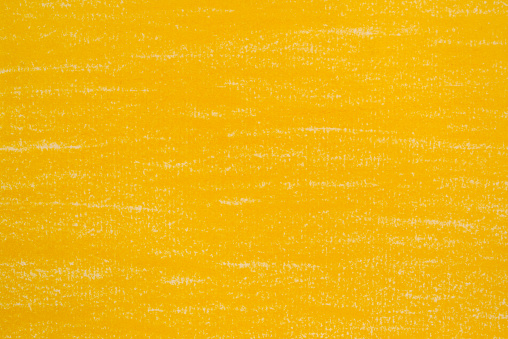 Yellow pencil drawings on white paper background texture.