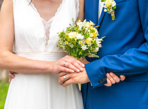 istock Bride and husband holding a flower bouquet 1087513778