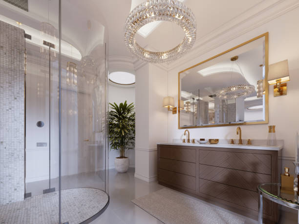 istock Modern bathroom with vanity and a mirror in a gold frame with sconces on the wall, a low table with decor, shower and a fashionable bath. 1087515312