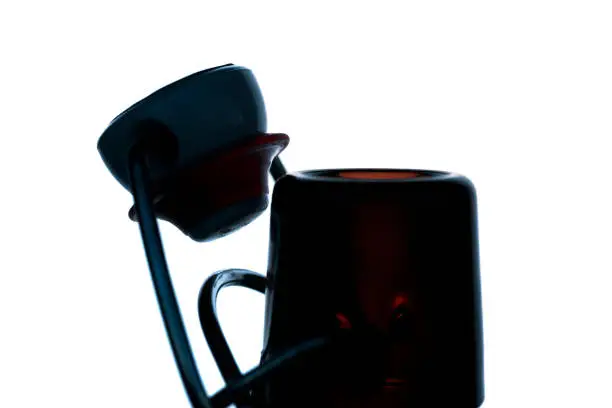 Close-up of the flip-top of a beer bottle isolated on white background as a silhouette.