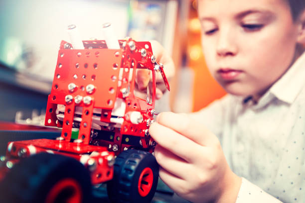 istock Boy turns a toy car 1087515676