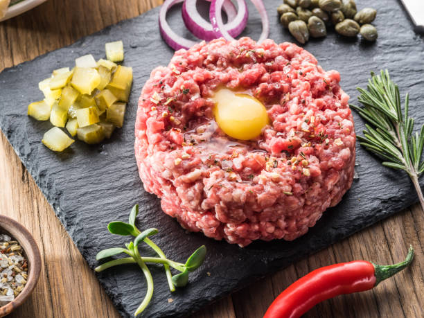 istock Steak tartare served with raw quail egg yolk, capers and bread. 1087516074
