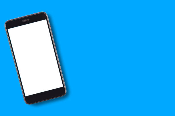istock Single black smartphone with isolated blank white screen on blue background with copy space for your text. Top view 1087517548