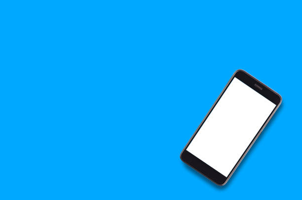istock Single black smartphone with isolated blank white screen on blue background with copy space for your text. Top view 1087517550