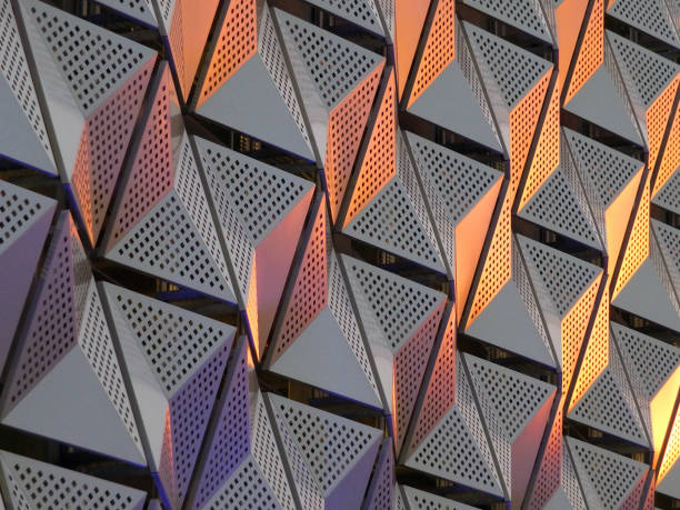 istock modern geometric triangular shiny silver steel cladding with highlights in gold and copper tones and perforated design 1087518394