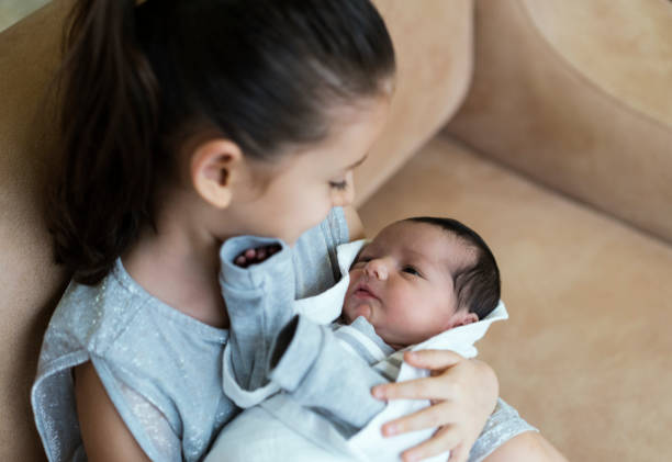 istock Cheerful girl with cute baby 1087519986