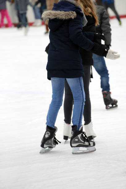 istock People skating on ice rink 1087524310