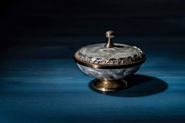 Vintage powder case on a blue wooden shelf