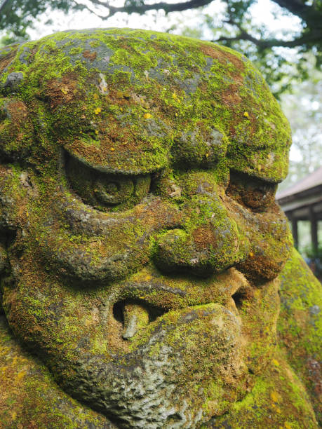 istock Close-up of a stone and moss statue in a forest in Bali 1087528710