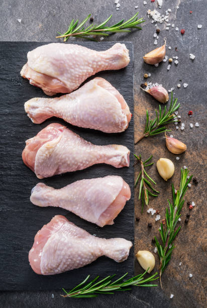 Chicken legs with spices and salt  ready for cooking. Chicken legs with spices and salt  ready for cooking on cutting board. drumstick stock pictures, royalty-free photos & images