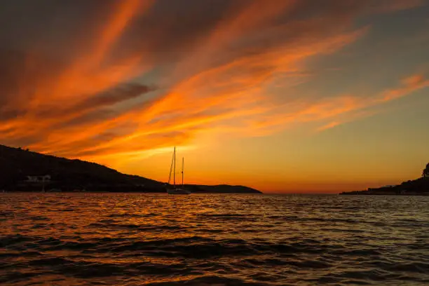 Sunset on a warm Greek summer night at the beach of Kassiopi on Corfu