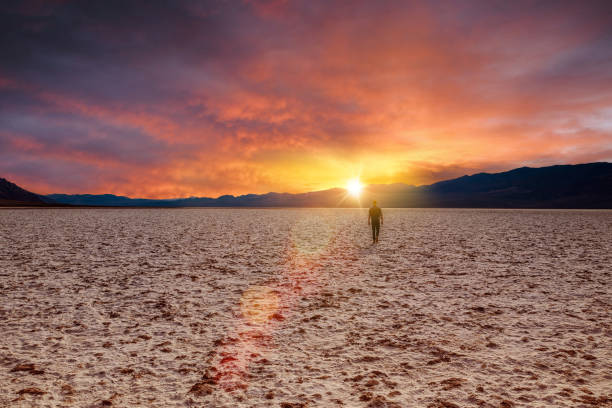 istock Adventurer looking at the sunset in the desert 1087544392