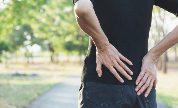 istock A woman suffering from backache, spinal injury and muscle issue problem at outdoor. 1087544888