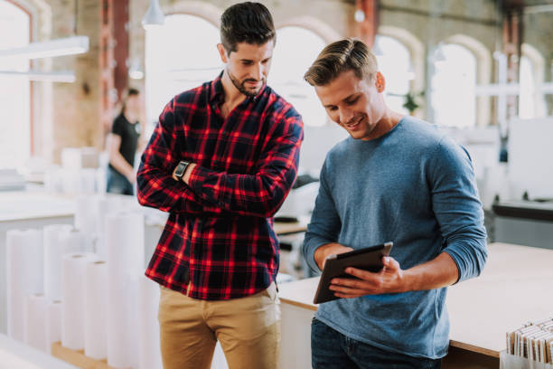 istock Positive male colleagues standing in the typography 1087547452