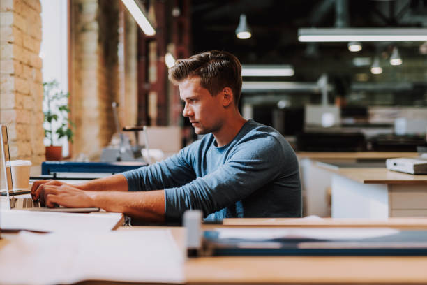 istock Perspective designer is concentrating on work at laptop 1087547610