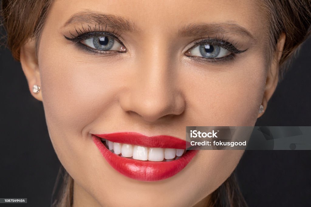 close-up portrait of a beautiful smiling girl close-up portrait of a beautiful smiling girl. the girl smiles a beautiful smile and shows snow-white straight teeth. Adult Stock Photo