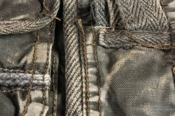 istock clothing items washed cotton fabric texture with seams, clasps, buttons and rivets 1087558832