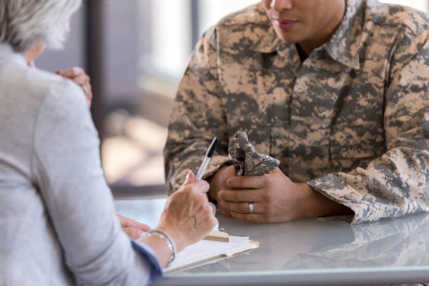 istock Male in uniform sits at table with female counselor 1087566226