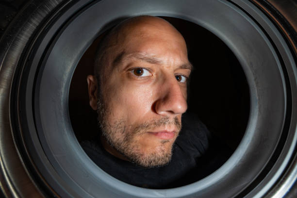 istock Portrait of man view from washing machine inside 1087568056