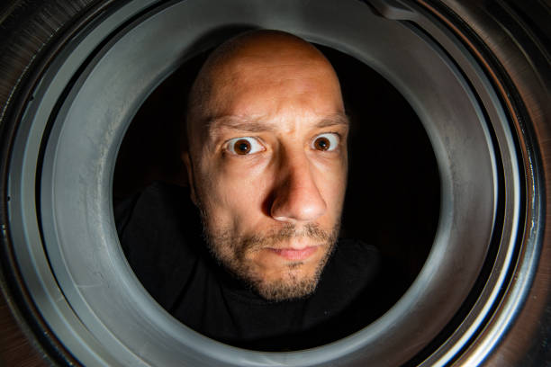 istock Portrait of man view from washing machine inside 1087568060