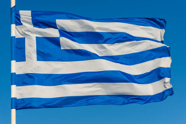 istock Greek flag on pole waving over blue background 1087570200