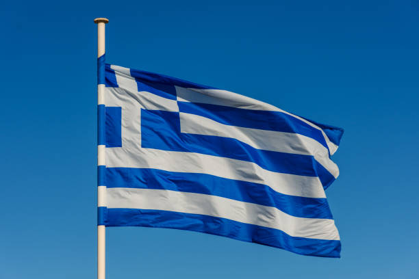 istock Greek flag on pole waving over blue background 1087570204