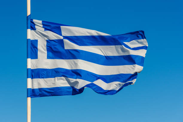 istock Greek flag on pole waving over blue background 1087570686