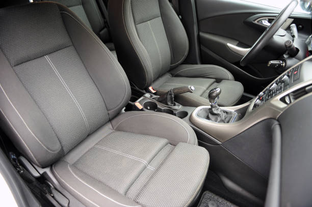 istock Modern luxury prestige car interior, dashboard, steering wheel. Black perforated leather interior. 1087572260