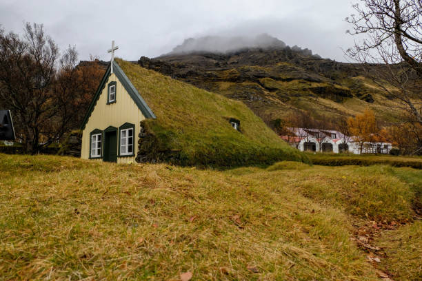 istock Small church cover with grass on roof 1087572516