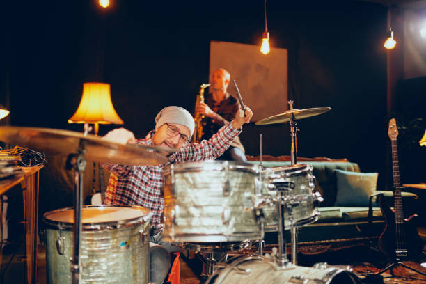 istock Two men playing drums and saxophone in home studio. 1087573144