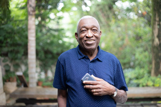 istock Afro Senior Man Using His Mobile Phone Portrait 1087574566