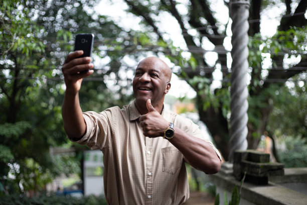 istock Afro Mature Man Using His Mobile Phone 1087574888