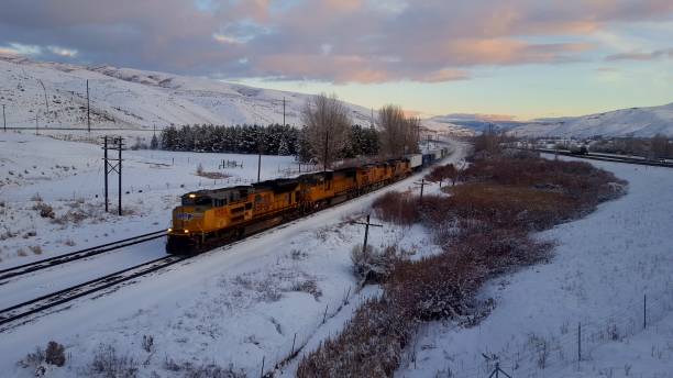 Train sunset Train passing by Ogden Utah while sun was setting on a cold, snowy, winter day. ogden utah photos stock pictures, royalty-free photos & images