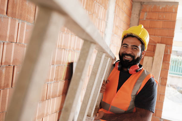 Portrait Of Happy Hispanic Worker Smiling In Construction Site stock photo