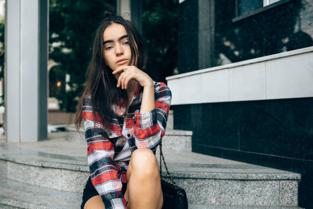 istock Young woman wearing red checkered shirt 1087585938