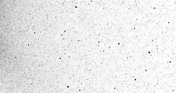 Photo of Black particles explosion isolated on white background; Abstract dust overlay texture