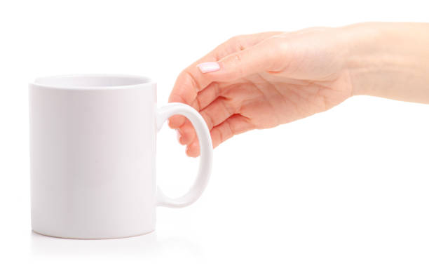 istock White cup mug in female hand 1087596246