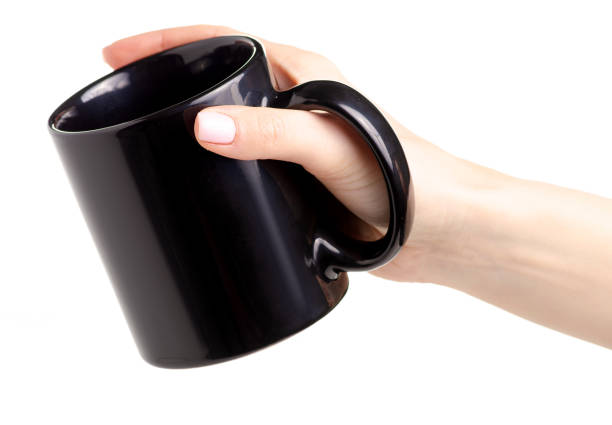 istock Black cup mug in female hand 1087596260