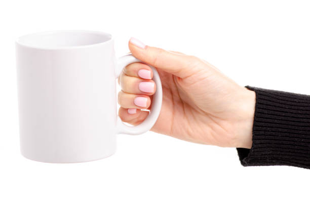 istock White cup mug in female hand 1087597494