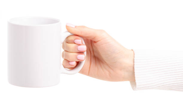 istock White cup mug in female hand 1087597522